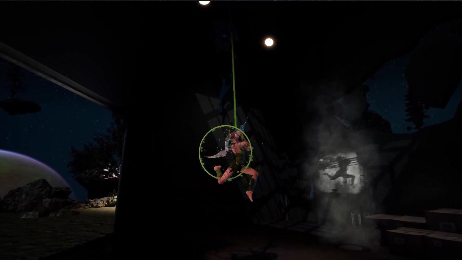 The fairy character curled inside the green aerial hoop, wings folded — smoke billowing from the right of frame with a live-performer silhouette just visible ghosting through it, moonlit Archipelago landscape and rocks on the left.